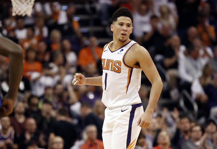 Devin Booker led a spirited run to give Phoenix their first win of the NBA season